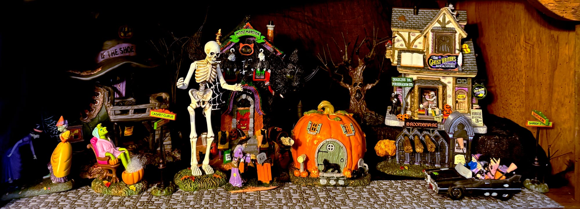 A level of Tina's Halloween village, featuring a row of colorful ceramic homes and townspeople.