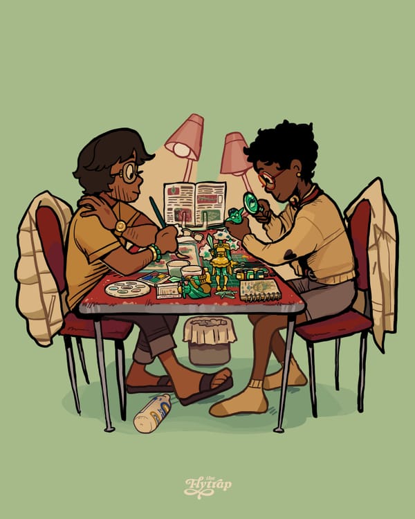 A Southeast Asian person and a Black person, both visually impaired, sit at a table cluttered with art supplies as they paint figurines.